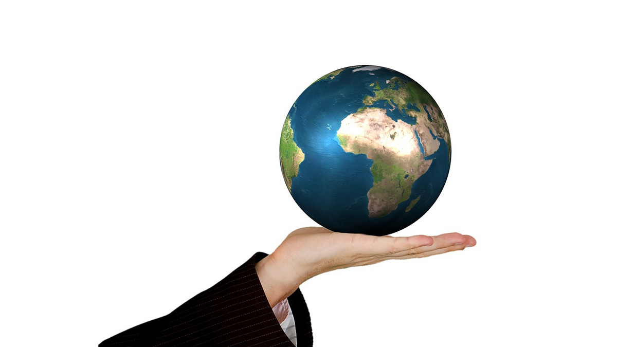 About us, 2Lift, a material handling company. Image of a male hand holding the Earth.
