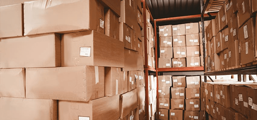Lots of cardboard boxes on shelves in a storage environment.