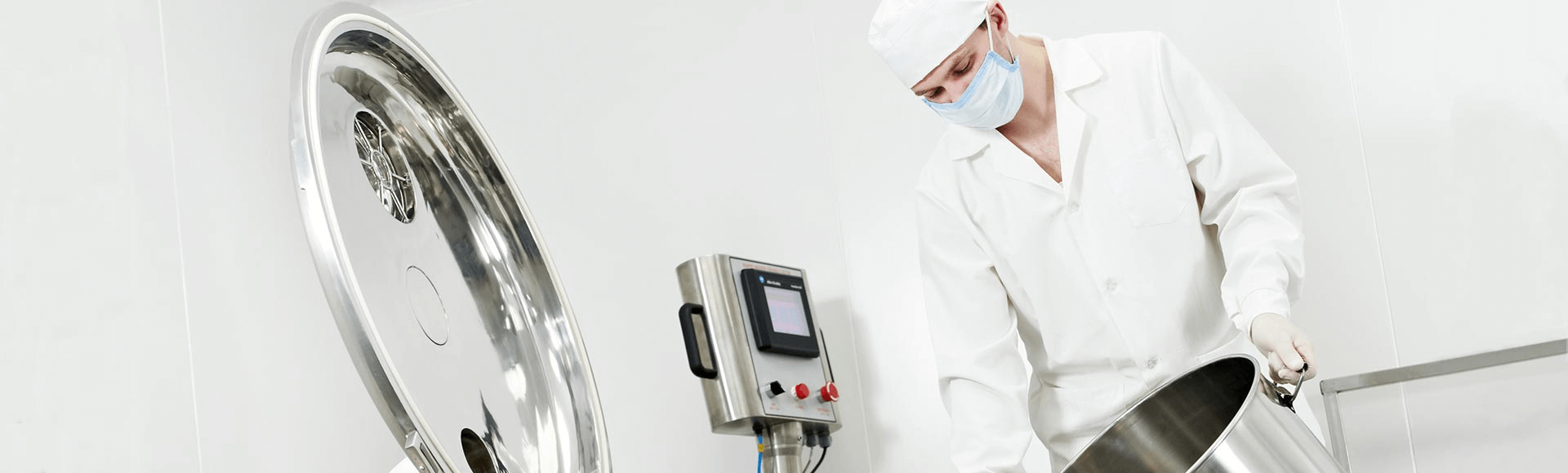 A man with a face mask in a white lab coat or uniform pouring out something from a container.