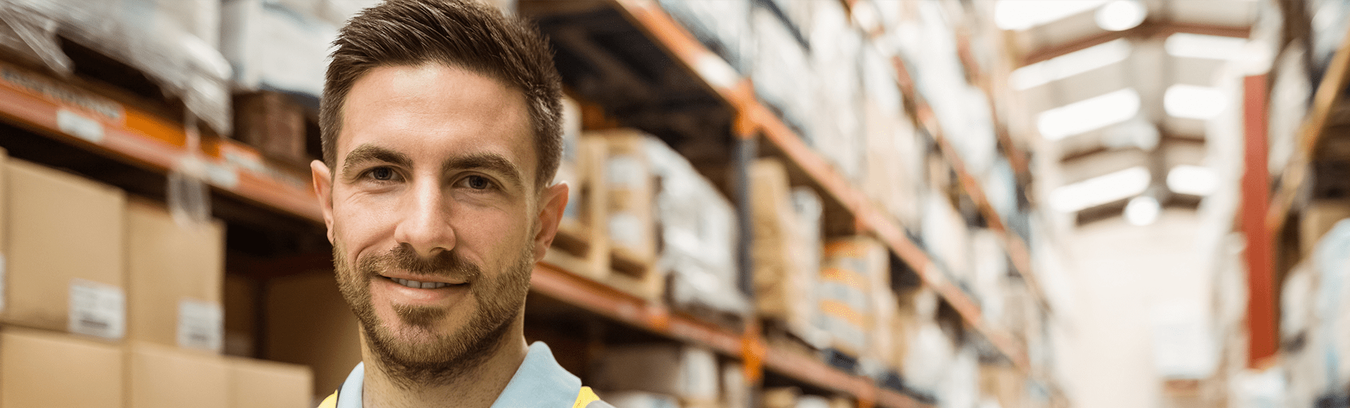 A large storage facility with the face of a smiling young man in the foreground.